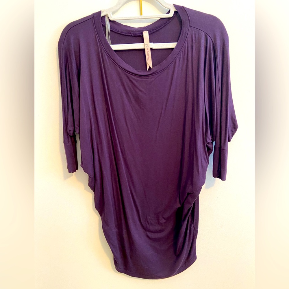 Purple three quarter sleeve loose fitting top.